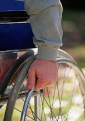 disabled person’s hand on wheelchair